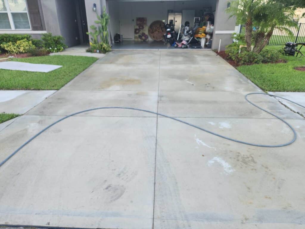 A newly cleaned garage driveway