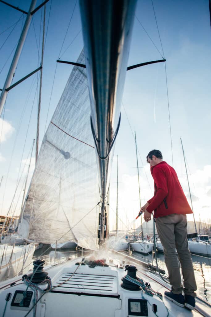 A yatchsman cleaning the deck of his boat